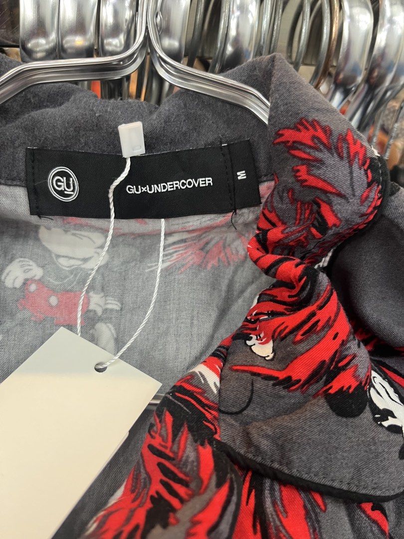 GU x UNDERCOVER Mickey Mouse Tropical Shirt (Category: Shirts) located in Manila. Submitted by shanaaa.collects (Listing ID 1469010793, Image 2). Description: - Brand: GU x UNDERCOVER collaboration - Design: Grey fabric with Mickey Mouse prints and red palm trees - Details: Short sleeves, lapel collar, branded buttons - Size: M - Material: Rayon - Condition: Brand new with tags (BNWT).