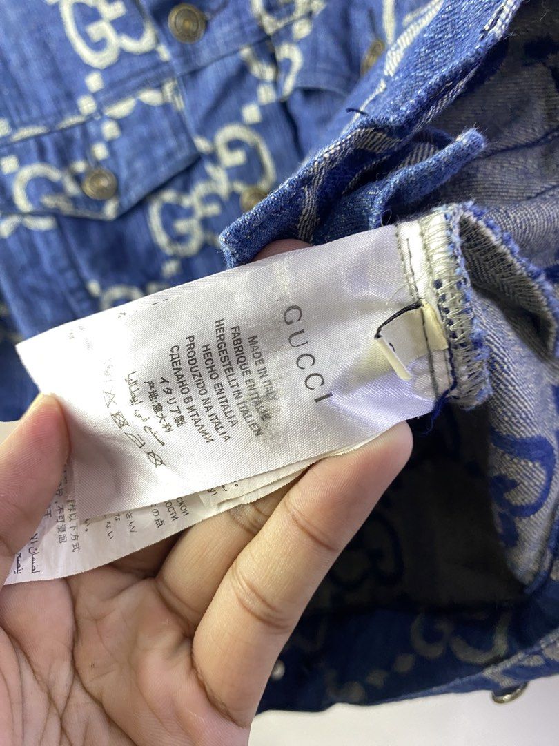 Gucci GG Denim Jacket Blue Size S (Category: Coats, Jackets and Outerwear) located in Manila. Submitted by declutterpromax (Listing ID 1468997475, Image 3). Description: - Brand: Gucci - Item: Blue Denim Jacket with All-Over White GG Monogram - Size: Small - Condition: Excellent / Like New - Details: Metallic logo buttons, two chest flap pockets, two side pockets, classic collar - Special Feature: Unique pineapple graphic inner neck label reading