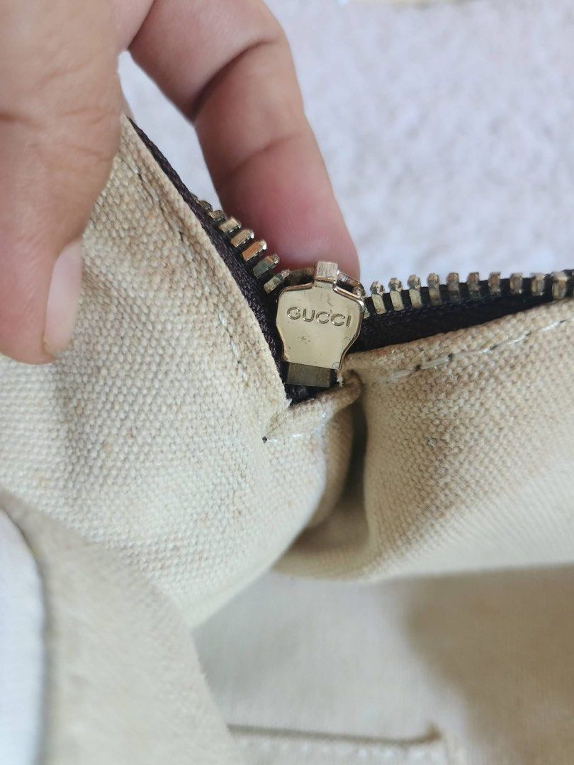 Gucci GG Monogram Canvas Tote Handbag (Category: Luxury Bags & Wallets) located in Bauang. Submitted by Fuzakenn (Listing ID 1469015990, Image 3). Description: - Brand: Gucci - Style: Monogram canvas tote bag with dark brown leather trim and handles - Closure: Top zip closure with engraved zipper pull - Interior: Fabric lining with slip pockets and a zippered pocket - Condition Notes: Hardware shows minor wear; interior lining has visible discolo
