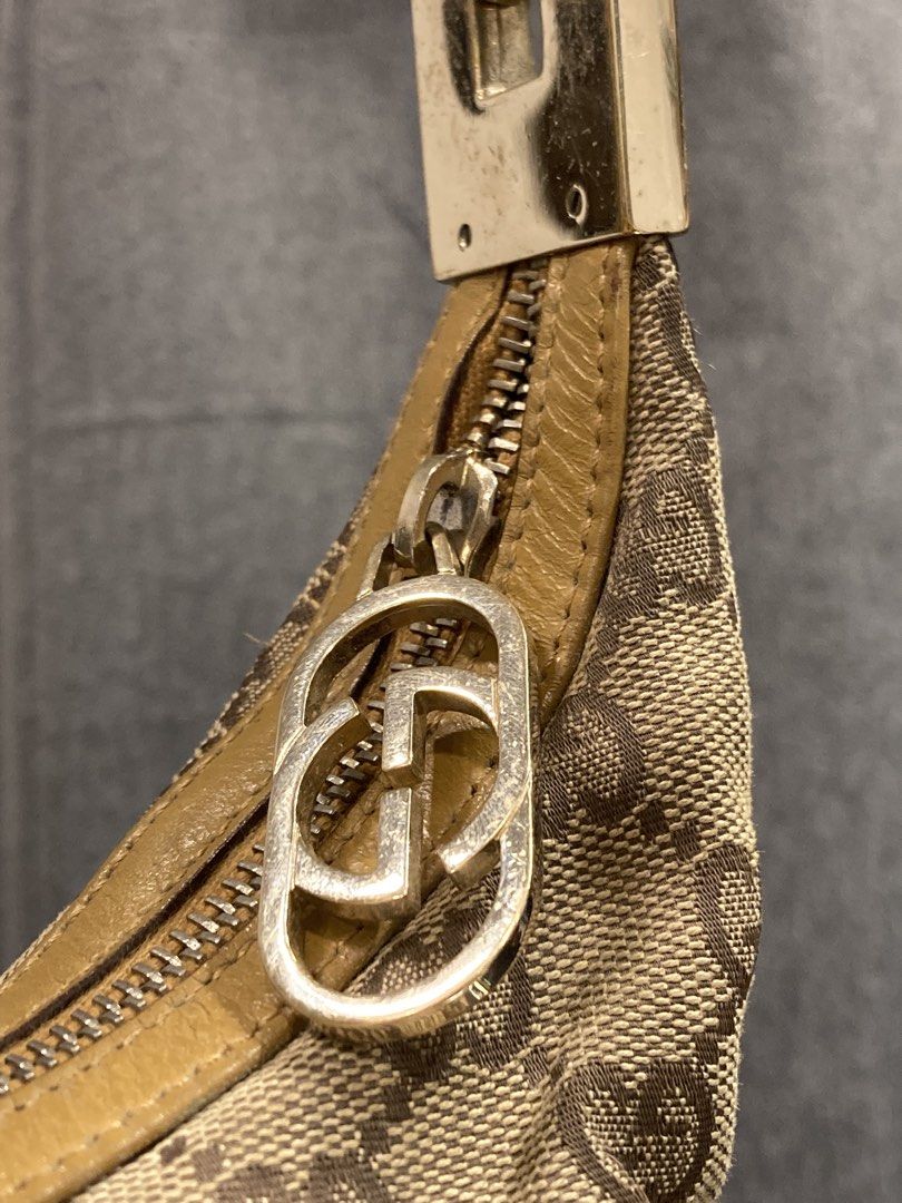 Gucci Monogram Canvas Shoulder Bag Tan (Category: Luxury Bags & Wallets) located in Quezon City. Submitted by janisu0303 (Listing ID 1469144648, Image 3). Description: Gucci Clasp Hobo 10,500 php Good condition Fairview area meetups Or shipping has beige monogram canvas with brown details. The hardware is gold. The item is in a very good vintage condition, but has general signs of wear. The measurements are 28 x 27 x 10 cm. The strap is 46 cm. Gu