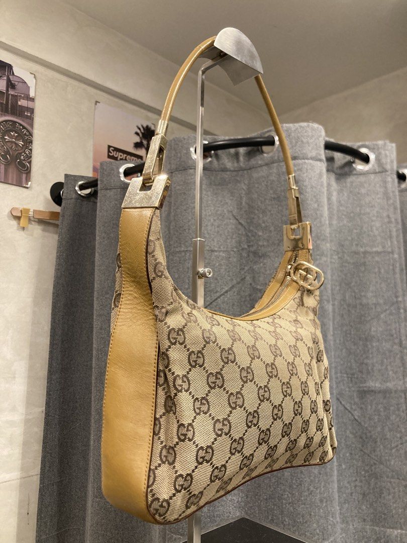 Gucci Monogram Canvas Shoulder Bag Tan (Category: Luxury Bags & Wallets) located in Quezon City. Submitted by janisu0303 (Listing ID 1469144648, Image 2). Description: Gucci Clasp Hobo 10,500 php Good condition Fairview area meetups Or shipping has beige monogram canvas with brown details. The hardware is gold. The item is in a very good vintage condition, but has general signs of wear. The measurements are 28 x 27 x 10 cm. The strap is 46 cm. Gu
