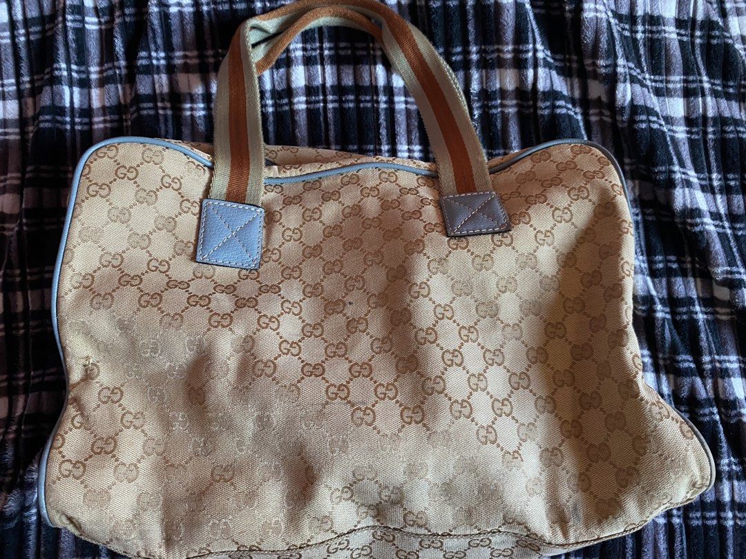 Gucci GG Fabric Duffle Bag (Category: Luxury Bags & Wallets) located in San Fernando. Submitted by keysjeyshop (Listing ID 1469109897, Image 2). Description: Vintage Gucci GG Fabric Duffle Bag -Size: Width - 20 Height - 11.5Depth - 7 -issue: faded print parts at the back of the back, the zipper handle broken and have some minor dents. - condition is still okay, using it for the last 7years. pm for more infos .