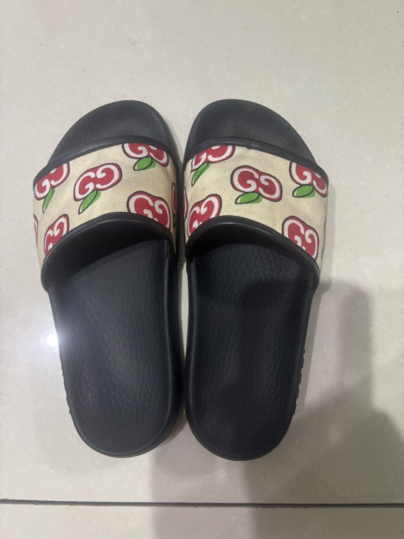 Gucci Slide Sandals with Apple and Interlocking G Print (Category: Sneakers & Footwear) located in Quezon City. Submitted by engr36 (Listing ID 1469158990, Image 1). Description: - Brand: Gucci - Item: Slide Sandals - Color/Pattern: Black with beige strap and red apple/interlocking G print - Design: Slip-on with textured black rubber footbed - Branding: Embossed Gucci logo on side and bottom sole - Condition: Gently worn, light scuffs on bottom s