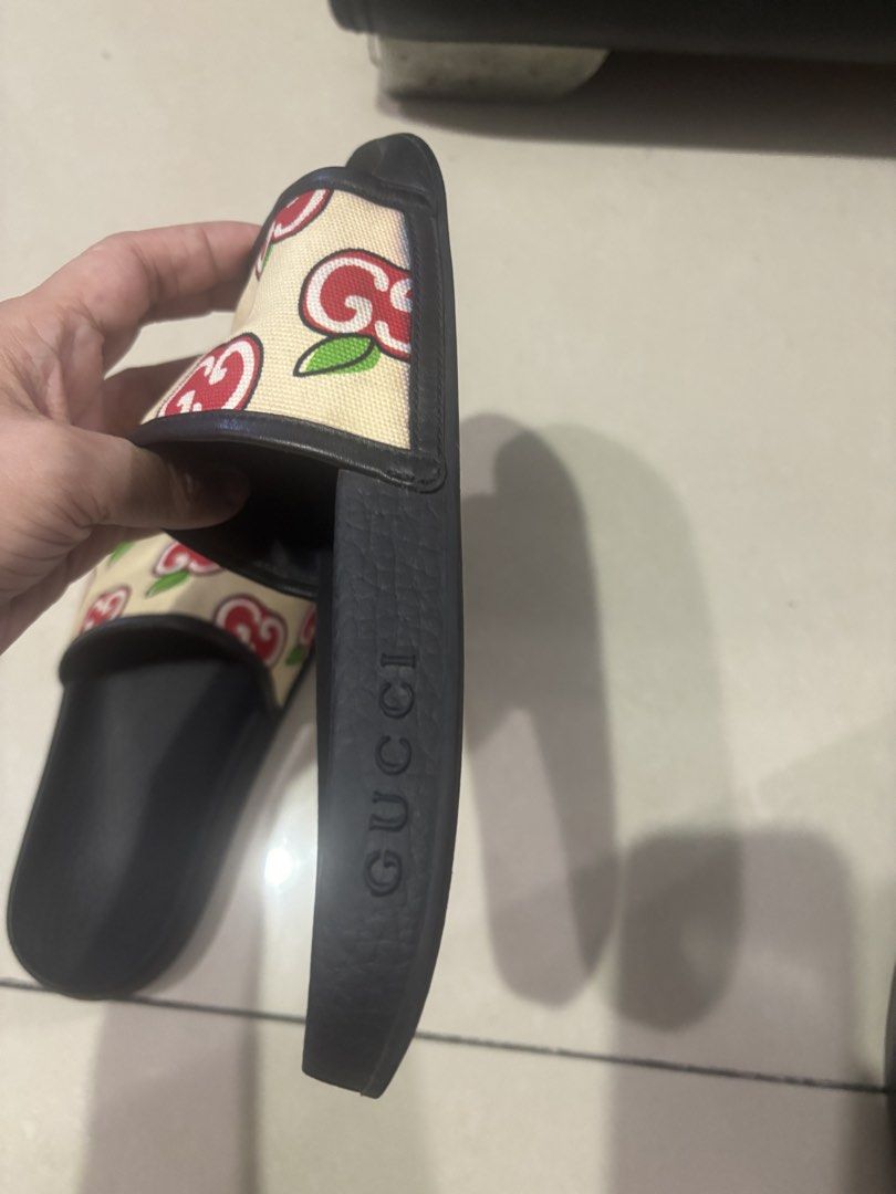 Gucci Slide Sandals with Apple and Interlocking G Print (Category: Sneakers & Footwear) located in Quezon City. Submitted by engr36 (Listing ID 1469158990, Image 3). Description: - Brand: Gucci - Item: Slide Sandals - Color/Pattern: Black with beige strap and red apple/interlocking G print - Design: Slip-on with textured black rubber footbed - Branding: Embossed Gucci logo on side and bottom sole - Condition: Gently worn, light scuffs on bottom s