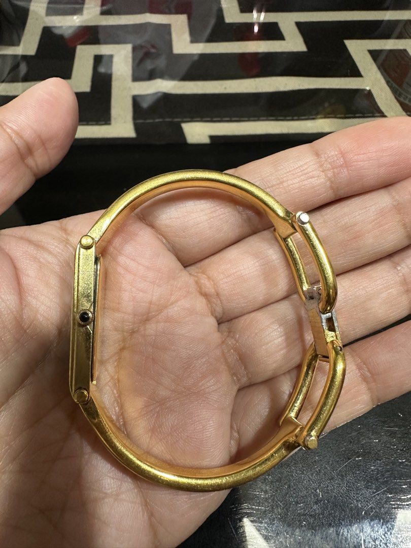Gucci watch (Category: Luxury Watches) located in Tarlac. Submitted by rizasdeclutteringonline2 (Listing ID 1468984899, Image 2). Description: Gucci watch -Gold Hardware - no battery(if bibilhin mo before ko ipadala papalagyan ng battery to make sure gumagana at di sira) -faded yun sa lock nya(as long as di sa mismong face or strap/bangle nya) - no cracks -used but not abuse. -not free and SF - I bought this ₱15,000 and selling it ₱9,000 and stil
