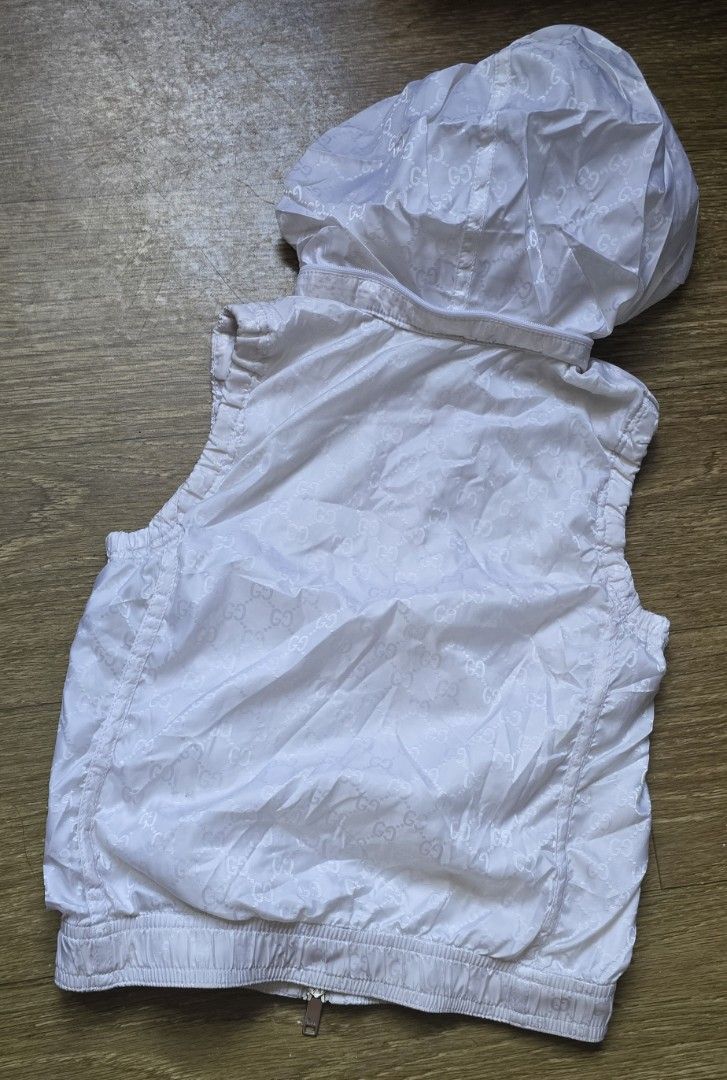 Gucci White Monogram Hooded Zip Vest (Category: Luxury Apparel) located in Quezon. Submitted by archivesss_666 (Listing ID 1469011136, Image 3). Description: for 6 yrs old - Authentic Gucci children's zip vest in white - Features all-over interlocking G monogram pattern - Stand collar with hidden zip-off hood - Ribbed hem and arm openings for a comfortable fit - Zip front closure with branded Gucci hardware - Inner Gucci tag and care label attach