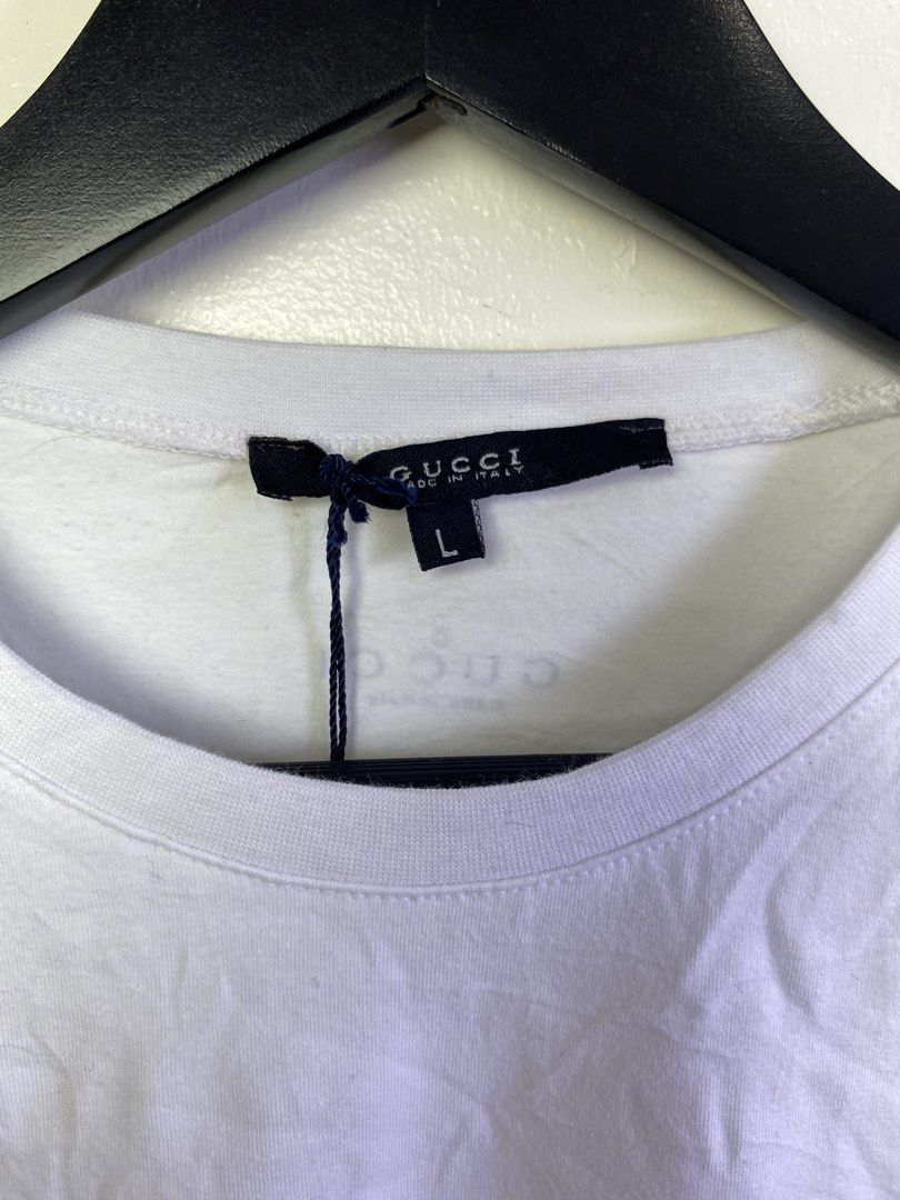Gucci White T-Shirt Size L (Category: Shirts) located in Manila. Submitted by declutterpromax (Listing ID 1468976362, Image 2). Description: - Brand: Gucci - Size: Large - Color: Clean White - Material: Cotton and Lycra blend (Made in Italy) - Style: Classic crew neck, short sleeves - Condition: Brand new with tag attached at the collar - Design: Minimalist with subtle inner neck and rear collar branding - Versatility: Great basic piece for casua
