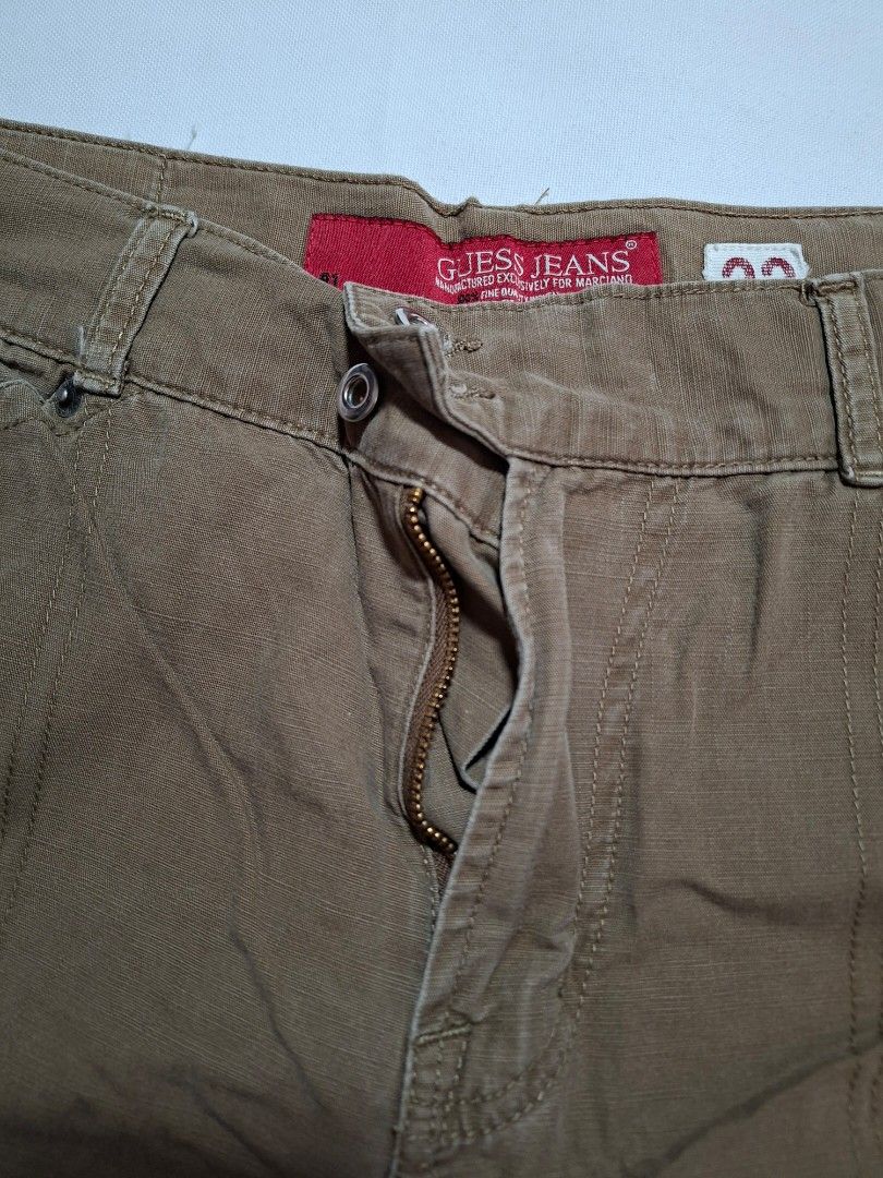 Guess Jeans Brown Pants Size 33 (Category: Coats, Jackets and Outerwear) located in Baguio. Submitted by restyrille77846 (Listing ID 1468979328, Image 2). Description: - Brand: Guess Jeans - Color: Brown - Size: Tagged size 33 - Material: 100% Cotton - Closure: Classic button fly with brand-stamped metal rivets - Details: Red brand label near the waistband - Fit: Straight leg cut, perfect for casual everyday wear.