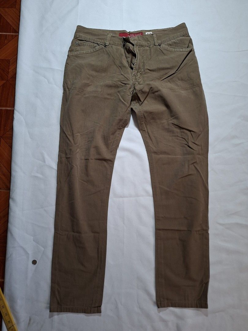 Guess Jeans Brown Pants Size 33 (Category: Coats, Jackets and Outerwear) located in Baguio. Submitted by restyrille77846 (Listing ID 1468979328, Image 1). Description: - Brand: Guess Jeans - Color: Brown - Size: Tagged size 33 - Material: 100% Cotton - Closure: Classic button fly with brand-stamped metal rivets - Details: Red brand label near the waistband - Fit: Straight leg cut, perfect for casual everyday wear.