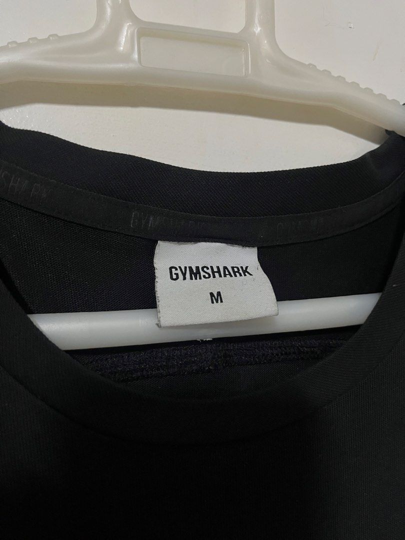 Gymshark Big Logo Tank Top Size (Category: Activewear) located in Quezon City. Submitted by oldbutgold1995 (Listing ID 1469108784, Image 2). Description: - Authentic Gymshark tank top in classic black - Bold white Gymshark logo across the chest - Size: Medium - Material: Comfortable, lightweight, and breathable cotton blend - Design: Sleeveless with a standard crew neckline, ideal for workouts - Easy to wash and maintain.