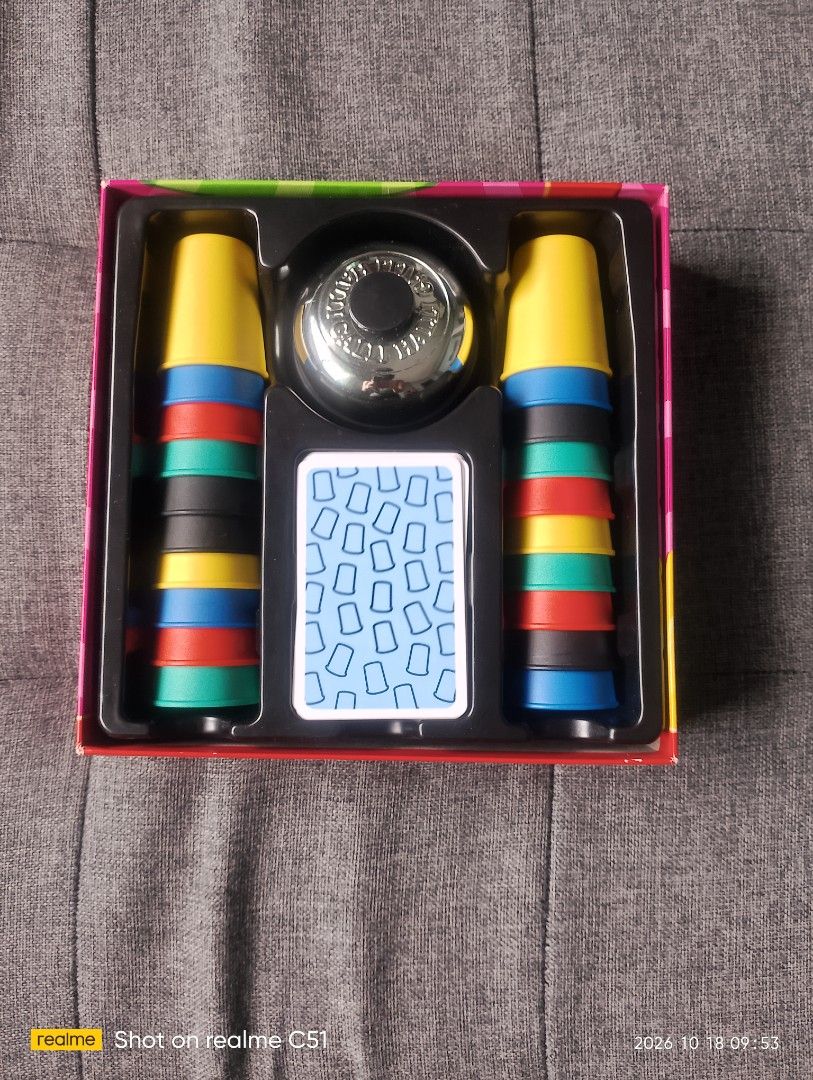 Halli Galli Cups Deluxe Board Game (Category: Board Games & Puzzles) located in Manila. Submitted by sunfl0w3r_50 (Listing ID 1469088284, Image 2). Description: - Game: Halli Galli Cups Deluxe by Amigo and Korea Board Games - Includes: 20 colorful cups (5 colors), metal call bell, and challenge cards - Players: Fast-paced family game for 2 or more players - Condition: Complete set in original plastic insert; box shows light shelf wear on corners 