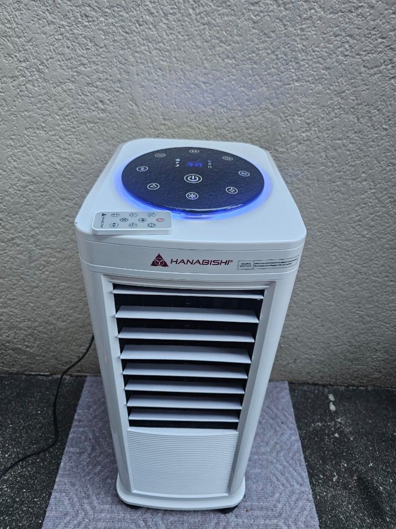 Hanabishi Tower Air Cooler with Remote Control (Category: Air Conditioning and Heating) located in Makati City. Submitted by beautiesandmore (Listing ID 1469020968, Image 2). Description: - Brand: Hanabishi Tower Air Cooler - Color: Sleek White - Control: Digital touch panel with blue LED ring + matching remote control - Cooling System: Honeycomb cooling pad with built-in water tank - Usage: Easy plug-and-play to cool down any room instantly.