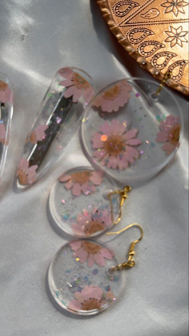 Handmade pressed flower jewelry sets and accessories (Category: Necklaces) located in Pasay City. Submitted by saroosss (Listing ID 1469087306, Image 2). Description: - Handmade clear resin jewelry and hair accessories - Encapsulates real pressed flowers with delicate glitter accents - Finished with premium gold or silver hardware - Ideal as a thoughtful gift or charming daily accessory - Message me to pick your favorite individual piece or set H