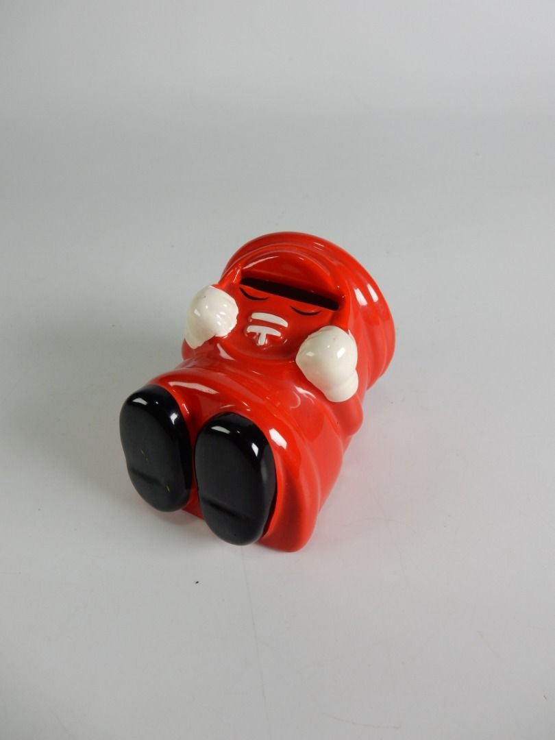 Happy Piggy Bank Japan Post (Category: Vintage Collectibles) located in Bacoor. Submitted by banananana12 (Listing ID 1469005474, Image 2). Description: - Adorable red ceramic mailbox piggy bank shaped like a classic pillar box - Features cute character hands and feet with a shiny glossy finish - Coin slot conveniently located right above the face - Smooth bottom to protect your desk or tabletop surfaces - Compact collectible piece ideal for desk