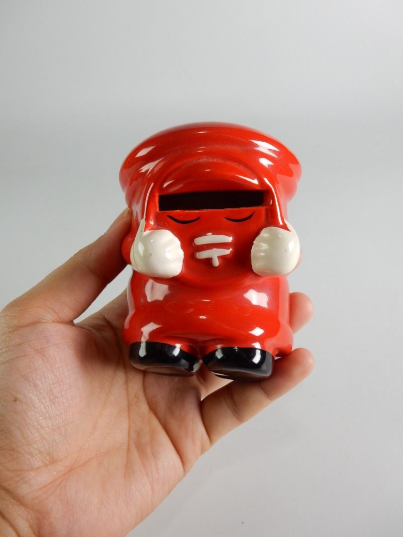 Happy Piggy Bank Japan Post (Category: Vintage Collectibles) located in Bacoor. Submitted by banananana12 (Listing ID 1469005474, Image 3). Description: - Adorable red ceramic mailbox piggy bank shaped like a classic pillar box - Features cute character hands and feet with a shiny glossy finish - Coin slot conveniently located right above the face - Smooth bottom to protect your desk or tabletop surfaces - Compact collectible piece ideal for desk