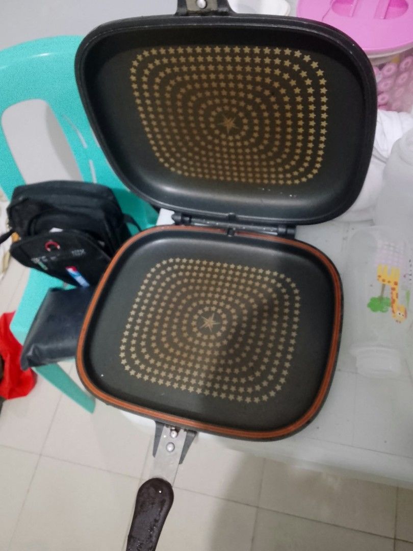 Happycall Double Sided Pan (Category: Cookware & Accessories) located in Quezon City. Submitted by bright.lenlen (Listing ID 1469074092, Image 2). Description: - Brand: Happycall double-sided pan - Size: Standard square - Interior: Star pattern coating with non-stick surface still intact - Build: Heavy-duty with a sturdy brown handle - Condition: Exterior shows normal signs of previous use and cooking residue, but fully functional.