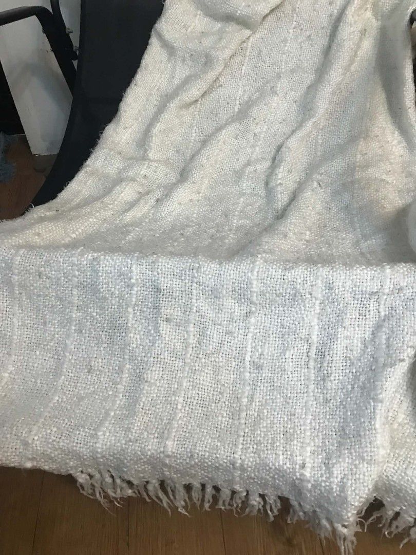 Hearth & Hand with Magnolia Textured White Throw Blanket (Category: Bedding & Towels) located in Imus. Submitted by stop_shop7 (Listing ID 1468985359, Image 2). Description: - Brand: Hearth & Hand with Magnolia - Color: Neutral white - Material: Chunky woven fabric with vertical striping - Design: Fringed edges and soft tassels at both ends - Origin: Made in India .