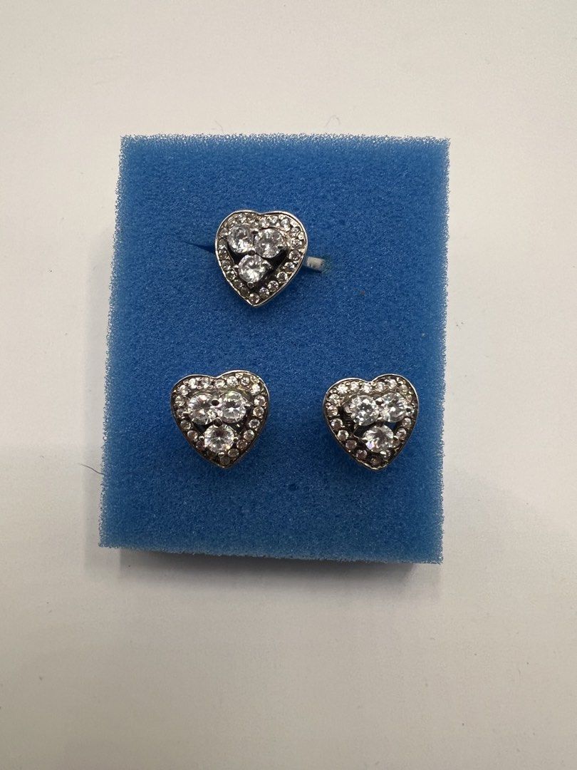 Heart-shaped rhinestone ring and matching earrings set (Category: Earrings) located in Meycauayan. Submitted by maricarfvelasco26 (Listing ID 1469077052, Image 1). Description: - Stunning heart-shaped jewelry set including a ring and two earrings - Silver-tone metal encrusted with tiny, sparkly clear crystals - Center features three larger round stones with a delicate pavé border - Perfect for gifting, special occasions, or dressing up an outfit 