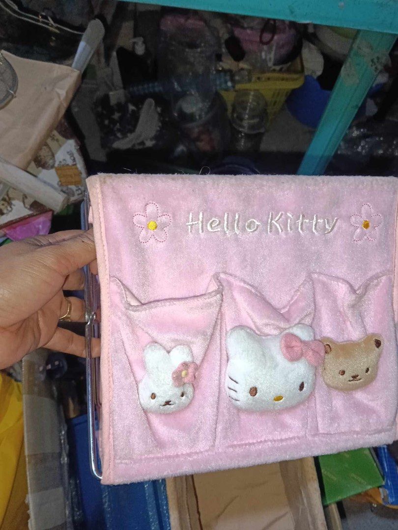 Hello Kitty Hanging Storage Organizer with Pockets (Category: Accessory Holder, Box & Organizers) located in Manila. Submitted by janetecson05 (Listing ID 1469089791, Image 2). Description: - Adorable Kitty hanging pocket organizer made with soft plush fabric - Features detailed embroidery with text and flowers - Includes 3 front pockets with cute 3D plush characters (a bunny, Kitty, and a bear) - Equipped with a sturdy collapsible metal frame st
