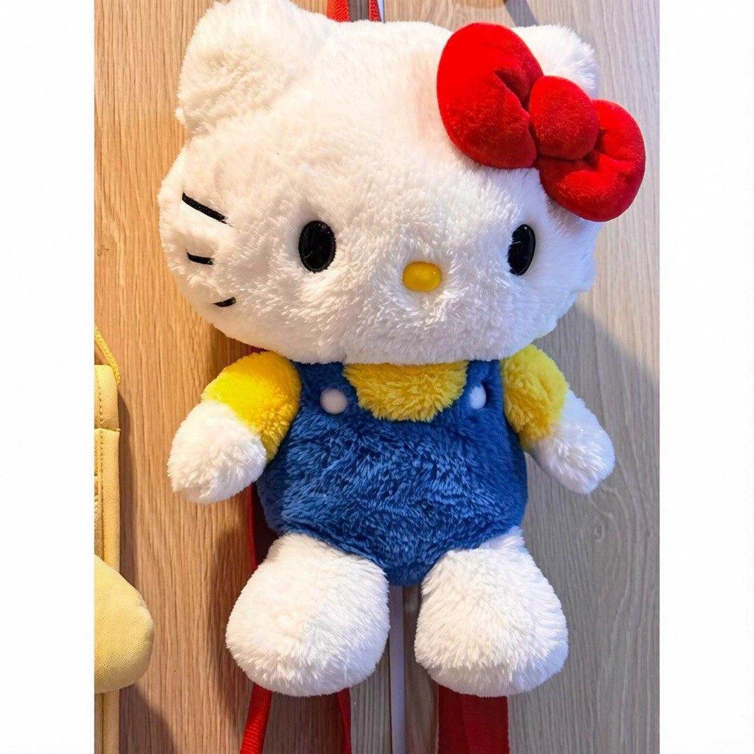 Hello Kitty Plush Backpack (Category: Backpacks) located in Guiguinto. Submitted by sheena4 (Listing ID 1469153802, Image 2). Description: - Adorable fluffy Kitty plush backpack design - Features cute blue overalls, yellow shirt, and red bow - Soft and huggable material with secure, adjustable red shoulder straps - Perfect size for carrying everyday small essentials like phone, wallet, and keys - Great daily accessory or gift for Sanrio and Kitty