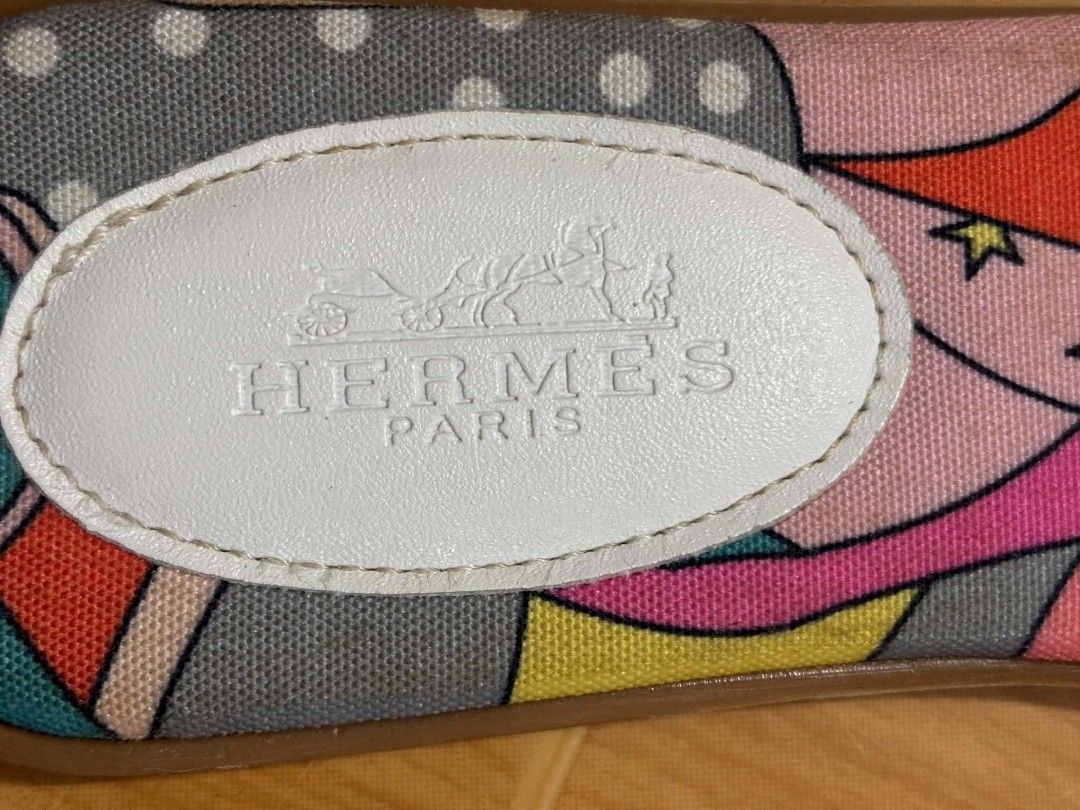 Hermès Oran Printed Canvas Sandals Size 37 (Category: Flats & Sandals) located in Paranaque City. Submitted by poego (Listing ID 1468955024, Image 3). Description: - Brand: Hermès - Style: Flat sandals with H-cut straps - Color/Material: White leather and multicolored patterned canvas footbed - Size: 37 (stamped on soles) - Origin: Made in Italy (Code: H-359 inside strap) - Condition: Visible wear and scuff marks on soles, clean inner branding.