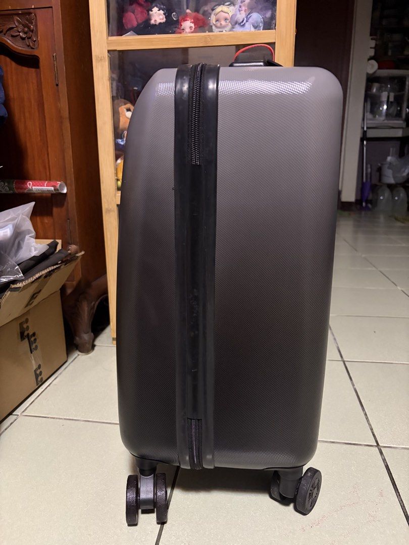 Herschel Grey Hardside Spinner Luggage (Category: Luggage) located in Makati City. Submitted by nicluttering (Listing ID 1469002748, Image 2). Description: - Brand: Herschel - Color: Grey hardside with vertical ribbed texture - Mobility: 4 smooth-rolling spinner wheels & telescoping pull handle - Security: Built-in side combination lock - Extras: Sturdy top handle with a decorative green and red ribbon, plus front rubber logo patch - Condition: N