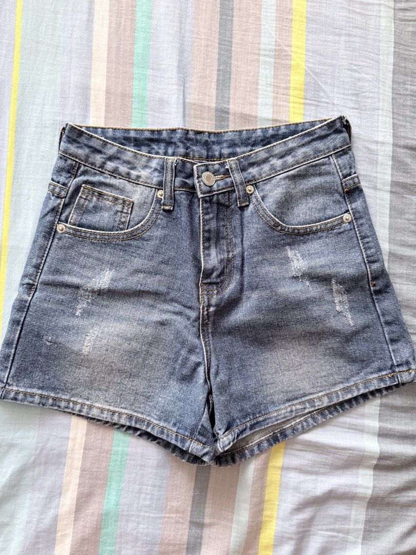 high-waisted denim shorts (Category: Shorts) located in Paranaque City. Submitted by roanclauds (Listing ID 1468950918, Image 1). Description: - High waist denim shorts in medium blue wash - Size: XS (24 in) - 100% cotton, designed by Korea - Distressed details on front and back pockets - Button closure and zip fly - Standard five-pocket styling with clean stitching and light fading.