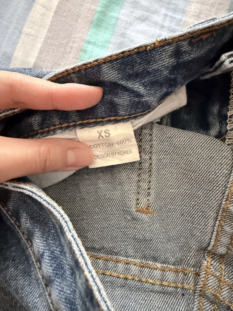 high-waisted denim shorts (Category: Shorts) located in Paranaque City. Submitted by roanclauds (Listing ID 1468950918, Image 3). Description: - High waist denim shorts in medium blue wash - Size: XS (24 in) - 100% cotton, designed by Korea - Distressed details on front and back pockets - Button closure and zip fly - Standard five-pocket styling with clean stitching and light fading.