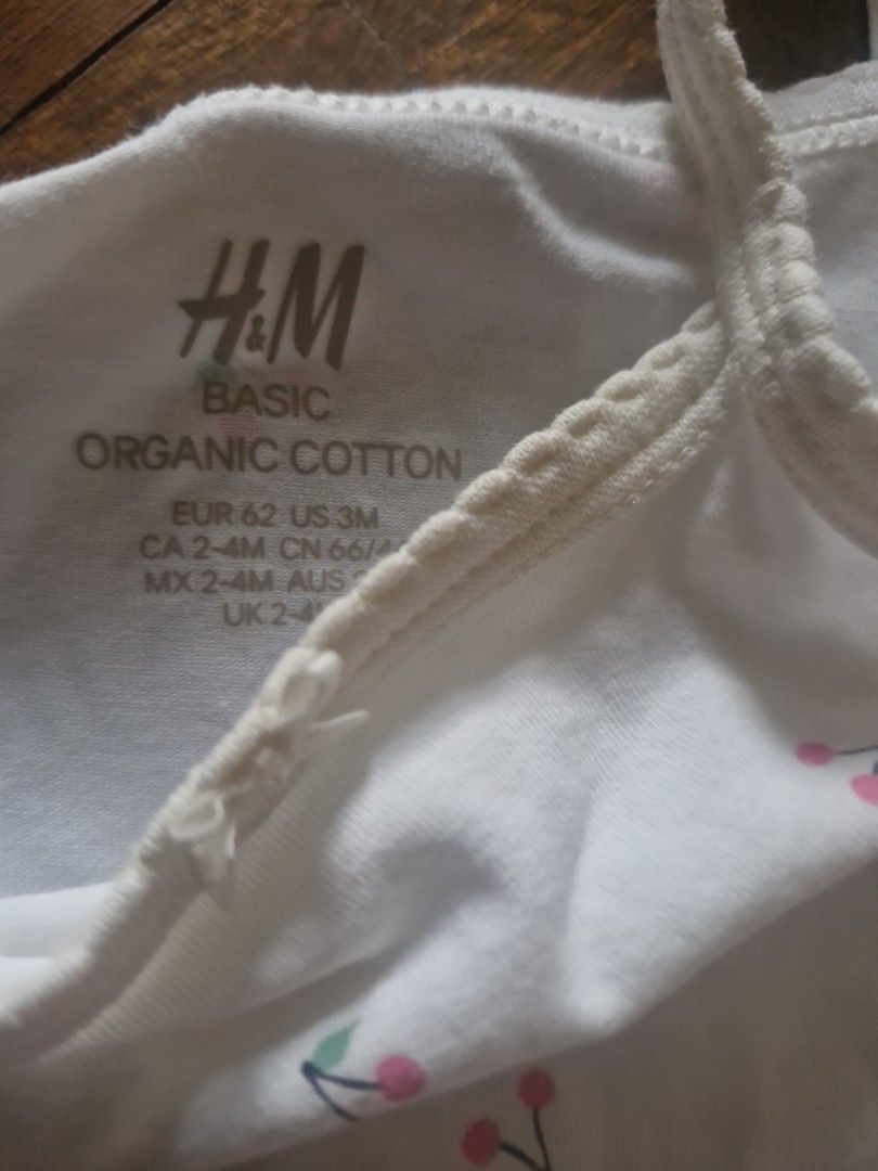 H&M Basic Organic Cotton Baby Bodysuits And Bloomer Set (Category: Babies & Kids Fashion) located in Cebu City. Submitted by minimi.cebu (Listing ID 1468934476, Image 3). Description: - Brand: H&M Basic - Size: EUR 62 / US 3M / CA 2-4M - Material: 100% organic cotton, ultra-soft and gentle on baby skin - Set includes: 1 white bodysuit with tiny cherry prints, 1 plain pink bodysuit, and 1 matching cherry print bloomer with ruffles - Features: Conv