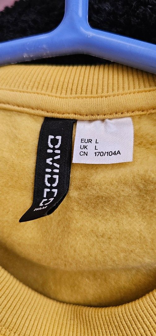 H&M Divided Yellow Colorblock Sweatshirt Size L (Category: Coats, Jackets and Outerwear) located in Antipolo. Submitted by pinkpandascloset (Listing ID 1469085607, Image 2). Description: - Brand/Style: H&M Divided colorblock sweatshirt - Size: L (170/104A tag sizing), relaxed and cropped fit - Colorway: Mustard yellow, dusty mauve, and white panels - Material: 59% cotton, 41% polyester with a soft fleece lining inside - Details: Crew neck, ribbed