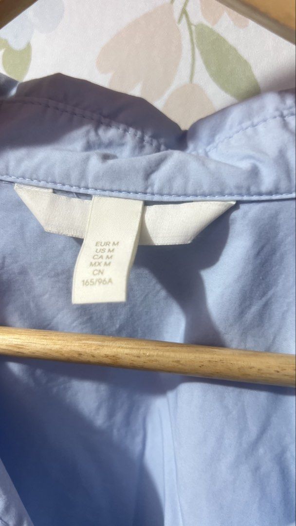 H&M Light Blue Oversized Button-Up Shirt Size M (Category: Shirts) located in Pasig City. Submitted by morilove (Listing ID 1469161569, Image 3). Description: - Brand: H&M - Color: Light Blue - Size: EUR M / US M (165/96A) - Fit: Relaxed, oversized with dropped shoulders - Material: Lightweight cotton - Features: Long sleeves, classic collar, buttoned cuffs, curved hem - Condition: Clean, excellent staple piece for layering or solo wear.