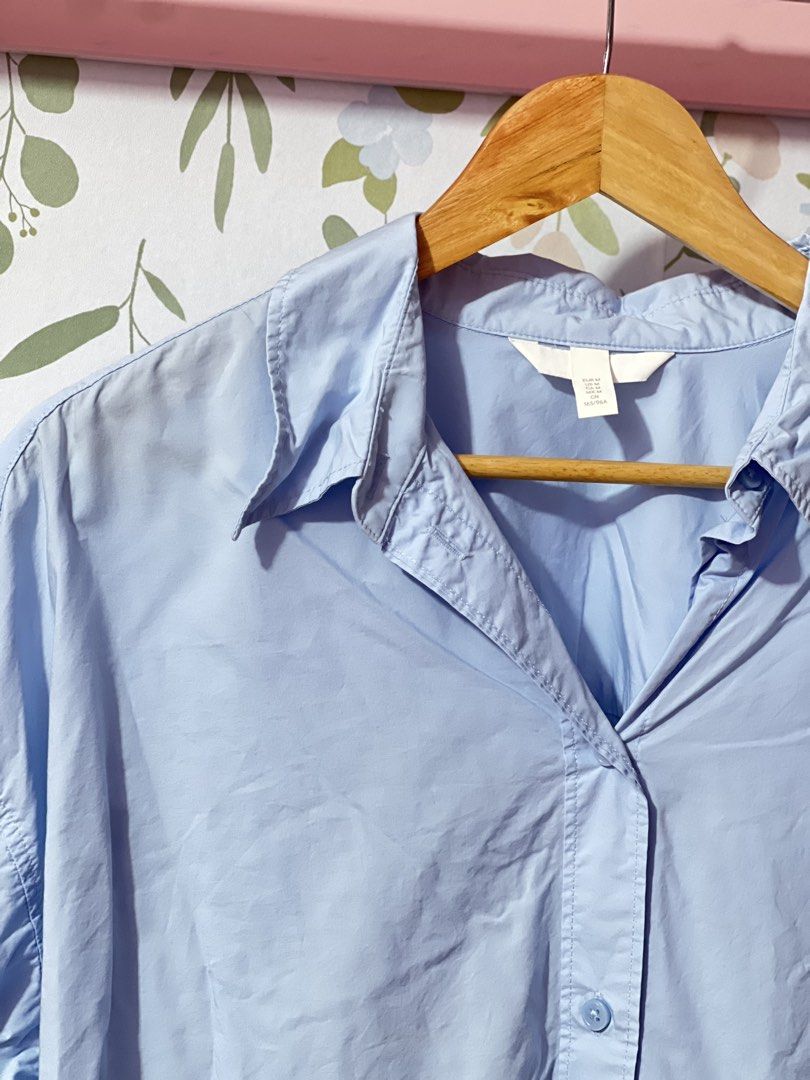 H&M Light Blue Oversized Button-Up Shirt Size M (Category: Shirts) located in Pasig City. Submitted by morilove (Listing ID 1469161569, Image 2). Description: - Brand: H&M - Color: Light Blue - Size: EUR M / US M (165/96A) - Fit: Relaxed, oversized with dropped shoulders - Material: Lightweight cotton - Features: Long sleeves, classic collar, buttoned cuffs, curved hem - Condition: Clean, excellent staple piece for layering or solo wear.