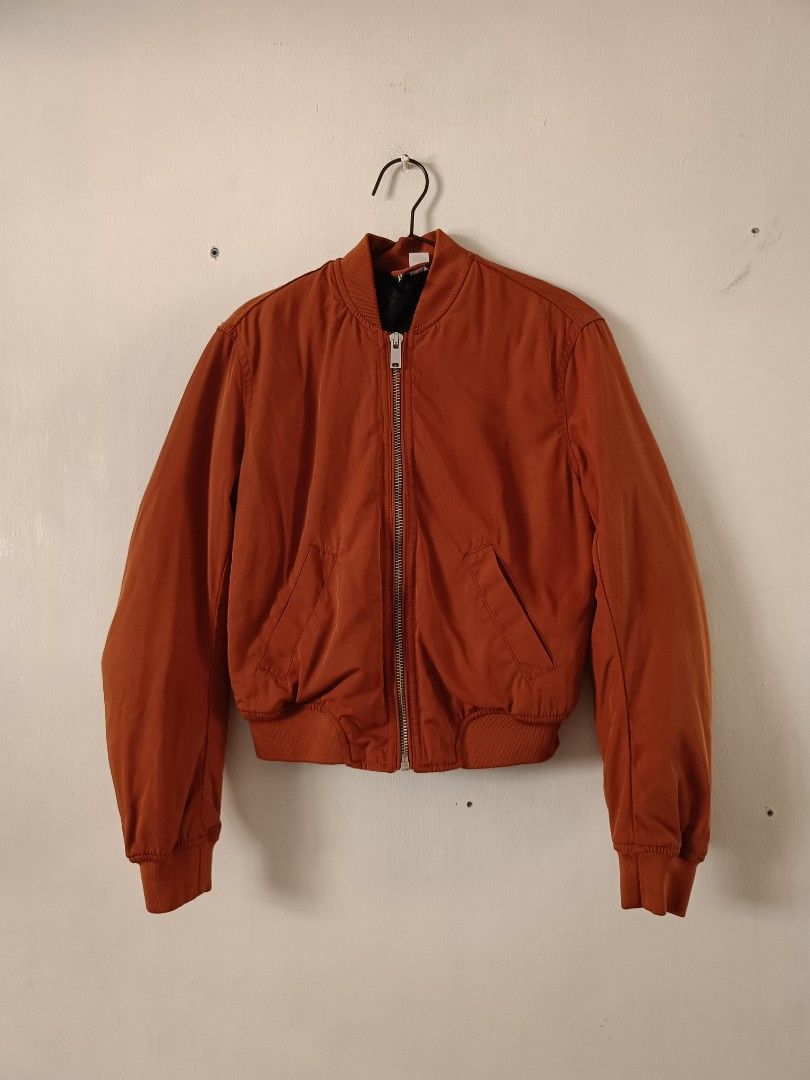 H&M Orange Reversible Bomber Jacket Black Quilted Lining (Category: Coats, Jackets and Outerwear) located in Manila. Submitted by shajanina.14 (Listing ID 1468956635, Image 1). Description: H&M Original Preloved As good as new XS- US As per measuring tape, Bust- up to 40 inches Waist- up to 38 inches Length- 21 inches .