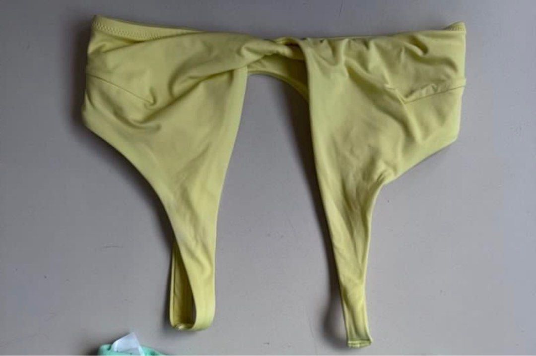 H&M yellow bikini top (Category: Bikinis & Swimsuits) located in Manila. Submitted by decluterthings888 (Listing ID 1468941228, Image 1). Description: - Brand: H&M - Color: Bright yellow - Size: EUR 34 / US 2 - Design: Front twist detail, plunging V-neckline, and wide straps - Material: Polyamide and elastane blend with comfortable polyester lining - Condition: Perfect for the beach or pool days.