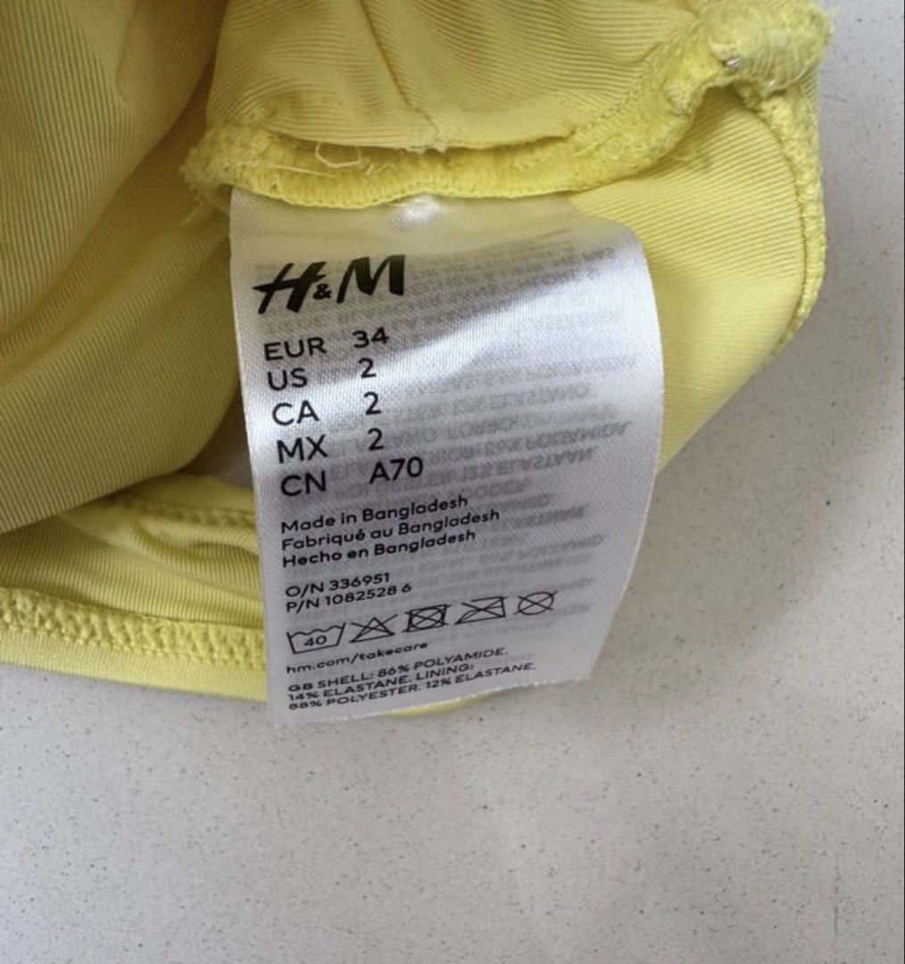 H&M yellow bikini top (Category: Bikinis & Swimsuits) located in Manila. Submitted by decluterthings888 (Listing ID 1468941228, Image 2). Description: - Brand: H&M - Color: Bright yellow - Size: EUR 34 / US 2 - Design: Front twist detail, plunging V-neckline, and wide straps - Material: Polyamide and elastane blend with comfortable polyester lining - Condition: Perfect for the beach or pool days.