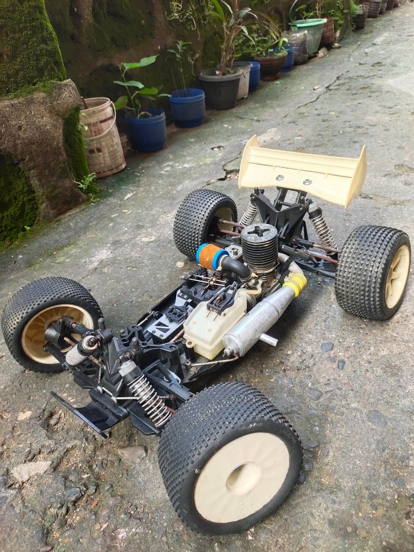 HoBao Racing Nitro Buggy RC Car (Category: Remote Control Toys) located in Caloocan City. Submitted by mjraymundo48160 (Listing ID 1468976527, Image 2). Description: - Brand/Model: HoBao Racing nitro RC buggy - Engine: Fuel engine with air filter attached - Chassis & Suspension: Aluminum chassis and shock absorbers - Wheels & Tires: Off-road tires mounted on white wheels - Electronics: Electronics box included on the deck -no body shell, need tx 