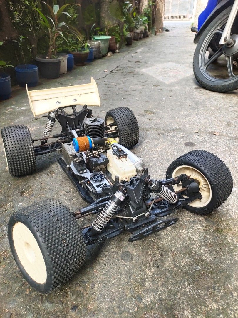 HoBao Racing Nitro Buggy RC Car (Category: Remote Control Toys) located in Caloocan City. Submitted by mjraymundo48160 (Listing ID 1468976527, Image 1). Description: - Brand/Model: HoBao Racing nitro RC buggy - Engine: Fuel engine with air filter attached - Chassis & Suspension: Aluminum chassis and shock absorbers - Wheels & Tires: Off-road tires mounted on white wheels - Electronics: Electronics box included on the deck -no body shell, need tx 