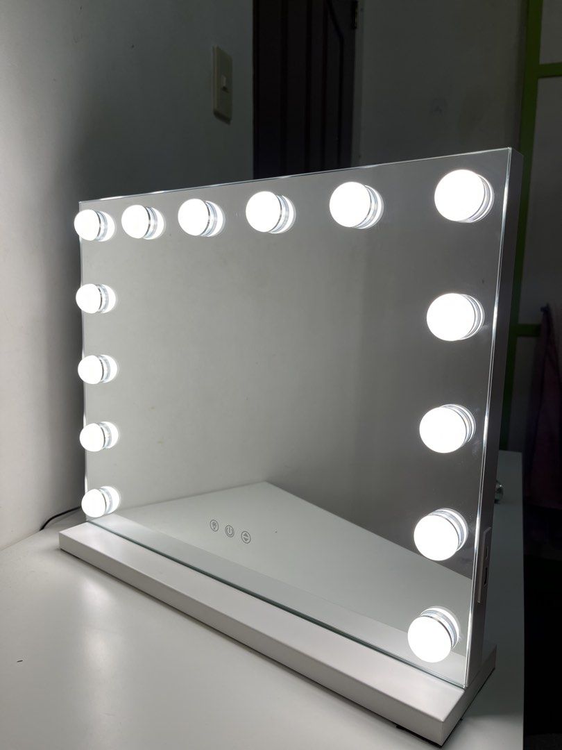 Hollywood Makeup Mirror with LED Bulbs and White Base (Category: Mirrors) located in Cavite. Submitted by luvysai (Listing ID 1468980714, Image 2). Description: 50cm 42cm - Large tabletop vanity mirror with all-around built-in LED bulbs - Sleek white rectangular wooden base with clean edges - Convenient touch sensor controls located at the bottom center - Bright, working lights perfect for flawless makeup application - Ideal addition to any white