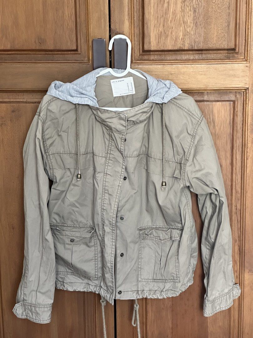 Hooded Utility Jacket Size S (Category: Coats, Jackets and Outerwear) located in Taguig. Submitted by melsofficewear (Listing ID 1468976659, Image 1). Description: - Color: Neutral beige with contrasting grey hooded insert - Closure: Full zip and secure snap button front - Pockets: Two functional front patch pockets with button flaps - Fit & Style: Adjustable drawstrings at the hem and hood, long sleeves with button cuffs - Condition: Great layer