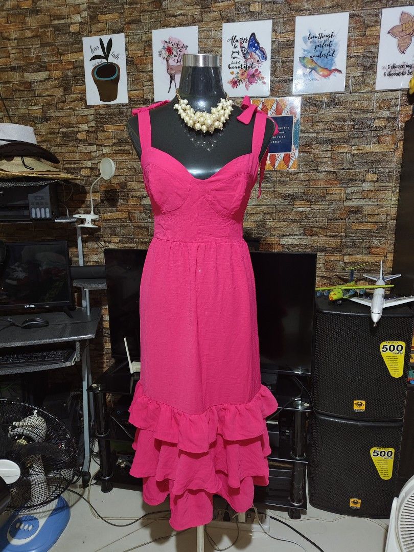 Hot Pink Ruffle Tiered Maxi Dress with Tie Straps (Category: Dresses) located in Manila. Submitted by duffy-080 (Listing ID 1468995708, Image 3). Description: - Color: Vibrant hot pink - Length: Midi - Neckline: Sweetheart neckline with structured bust cups - Straps: Self-tying in matching fabric - Design: Fitted bodice, flared gathered skirt, and three tiered bottom ruffles - Fabric: Lightweight with subtle texture - Closure: Back zip - Occasion