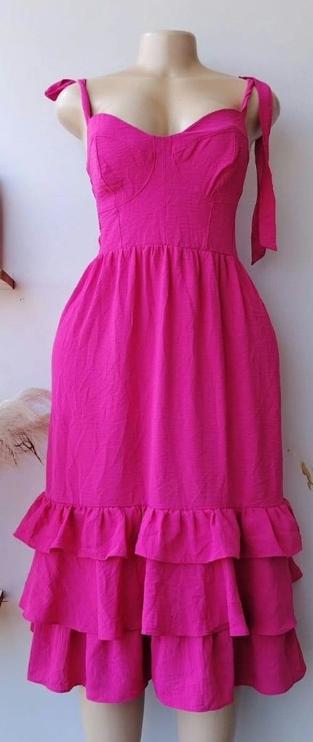 Hot Pink Ruffle Tiered Maxi Dress with Tie Straps (Category: Dresses) located in Manila. Submitted by duffy-080 (Listing ID 1468995708, Image 2). Description: - Color: Vibrant hot pink - Length: Midi - Neckline: Sweetheart neckline with structured bust cups - Straps: Self-tying in matching fabric - Design: Fitted bodice, flared gathered skirt, and three tiered bottom ruffles - Fabric: Lightweight with subtle texture - Closure: Back zip - Occasion
