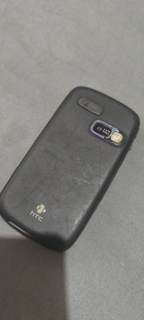 Htc tytn II (Category: Early Generation Mobile Phones) located in Quezon City. Submitted by thehouseofclassics (Listing ID 1468941196, Image 3). Description: - Brand/Model: HTC TyTN II - Classic Windows Mobile smartphone with slide-out QWERTY keyboard - Equipped with a 3.0 MP camera and flash - Visible scratches and wear on the back cover and body indicating past use - Ideal collector's item or display piece for retro tech lovers issue: no batter
