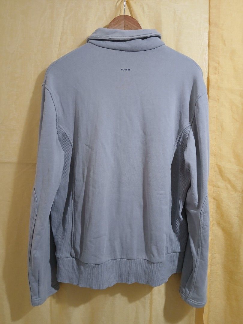 HUGO BOSS Full Zip Jacket Light Blue Size L (Category: Coats, Jackets and Outerwear) located in Taguig. Submitted by thriftnilhan (Listing ID 1468942741, Image 2). Description: - Brand: HUGO BOSS - Size: L - Color: Light Blue - Origin: Made in Thailand - Design: Full zip with ribbed side panels, collar, cuffs, and hem - Pockets: Front zip pockets featuring subtle contrast stitching - Branding: BOSS logo printed on the back near the collar - Care: