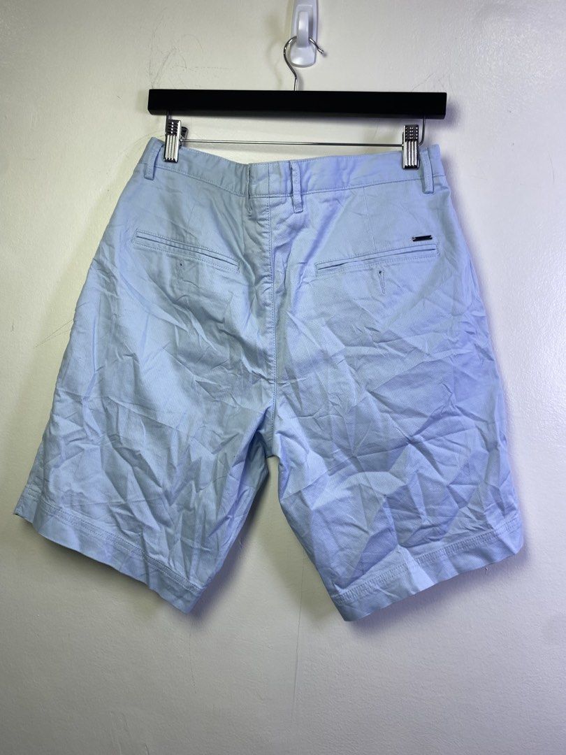 Hugo Boss Light Blue Textured Shorts Size 32 (Category: Shorts) located in Manila. Submitted by declutterpromax (Listing ID 1468976402, Image 3). Description: - Brand: Hugo Boss - Color: Light blue with textured fabric - Size: 32 waist (10-inch inseam) - Closure: Button fly - Pockets: Front slant pockets and dual back welt pockets with button closures - Details: Signature small metal Hugo Boss logo plate on the right back pocket - Condition: Grea
