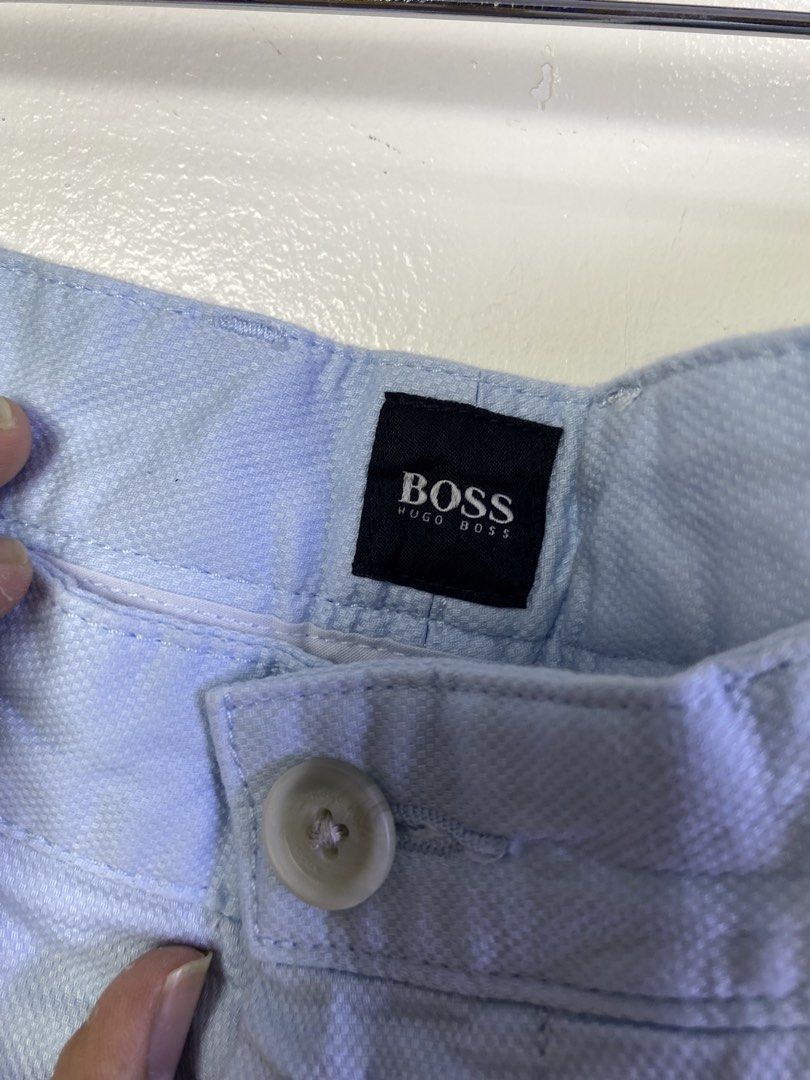 Hugo Boss Light Blue Textured Shorts Size 32 (Category: Shorts) located in Manila. Submitted by declutterpromax (Listing ID 1468976402, Image 2). Description: - Brand: Hugo Boss - Color: Light blue with textured fabric - Size: 32 waist (10-inch inseam) - Closure: Button fly - Pockets: Front slant pockets and dual back welt pockets with button closures - Details: Signature small metal Hugo Boss logo plate on the right back pocket - Condition: Grea