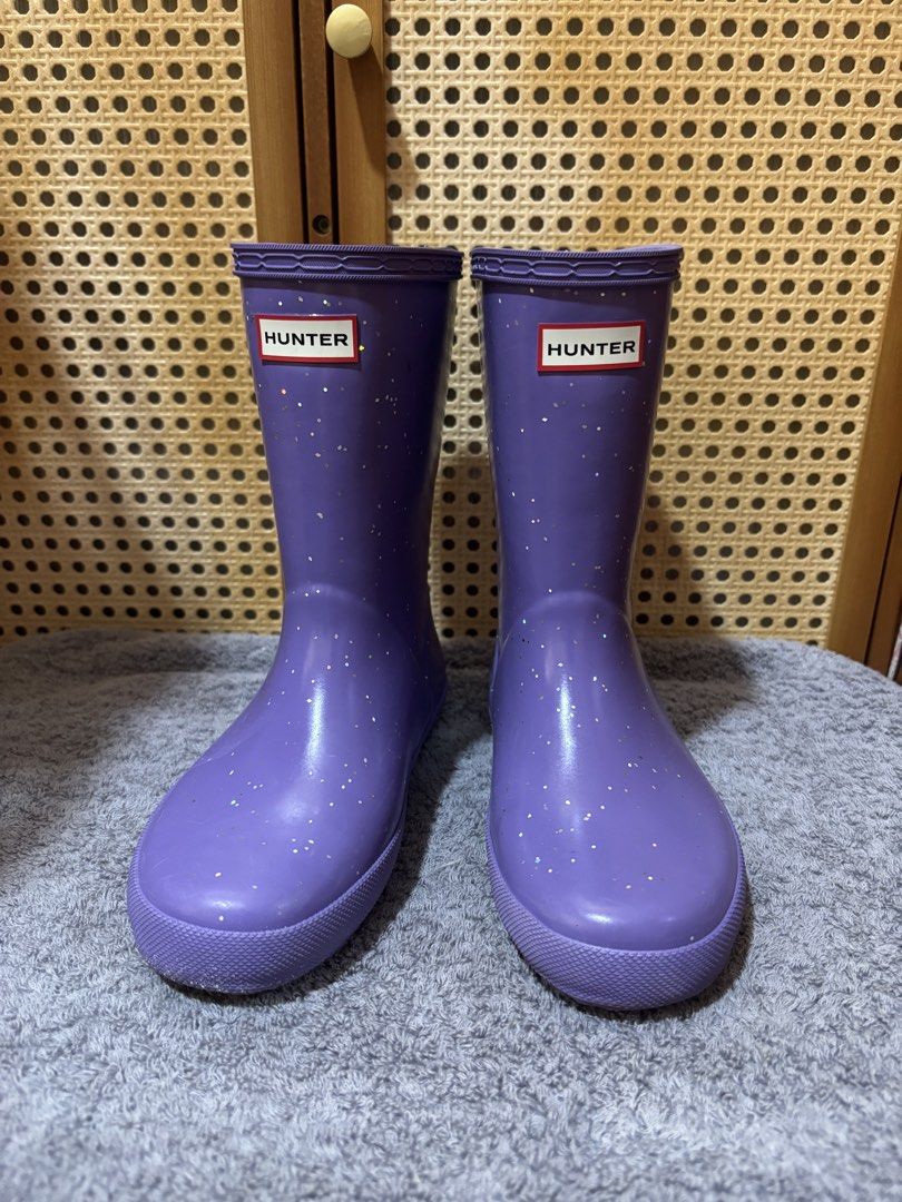 Hunter Purple Glitter Rain Boots (Category: Babies & Kids Fashion) located in Manila. Submitted by wardrobeinmnl (Listing ID 1469048137, Image 1). Description: SIZE: 13(US) - Authentic Hunter rain boots in a fun bright purple shade - Covered in eye-catching silver glitter specks all over - Mid-calf height featuring classic textured rubber toe cap - Adjustable side buckle detail for a better fit - Distinctive red and white Hunter logo patch on the
