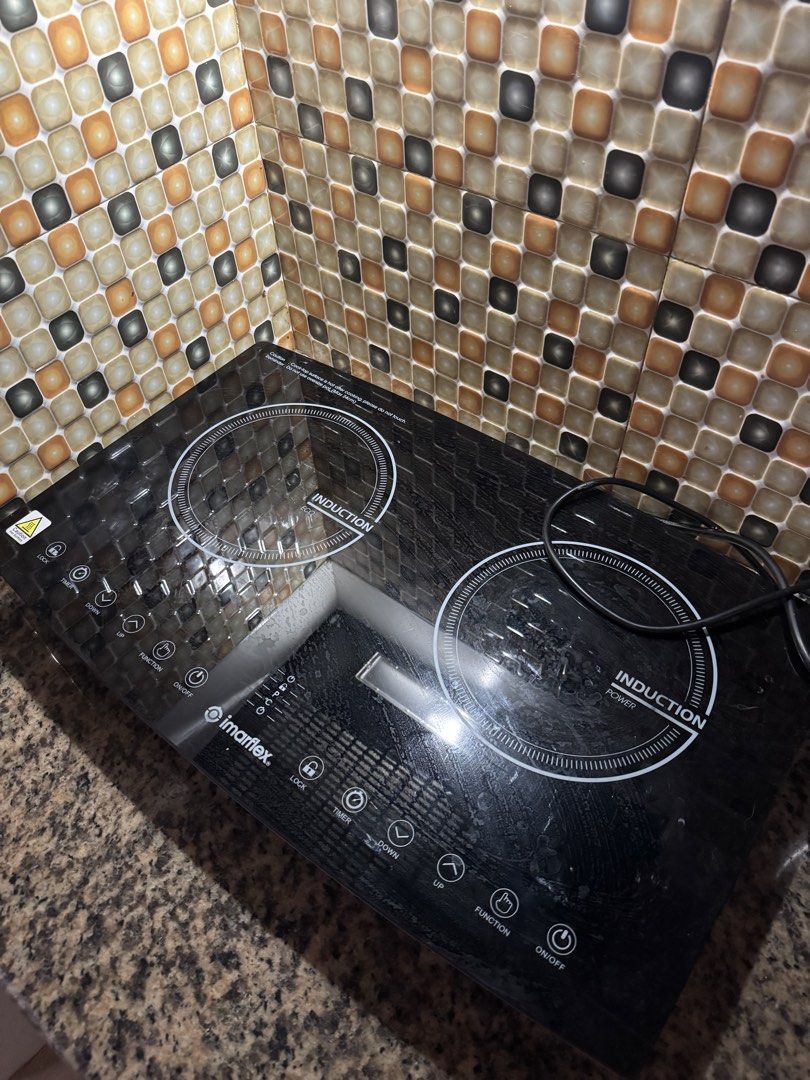 Imarflex Double Burner Induction Cooker (Category: Cookers) located in Makati City. Submitted by bell307 (Listing ID 1469143328, Image 1). Description: - Brand: Imarflex - Type: Dual burner induction cooktop - Design: Sleek black glass surface with clear cooking circles - Controls: Individual touch controls and digital display panel - Power: Standard plug attached, cooks two pots simultaneously - Benefit: Safe, clean, and efficient cooking withou