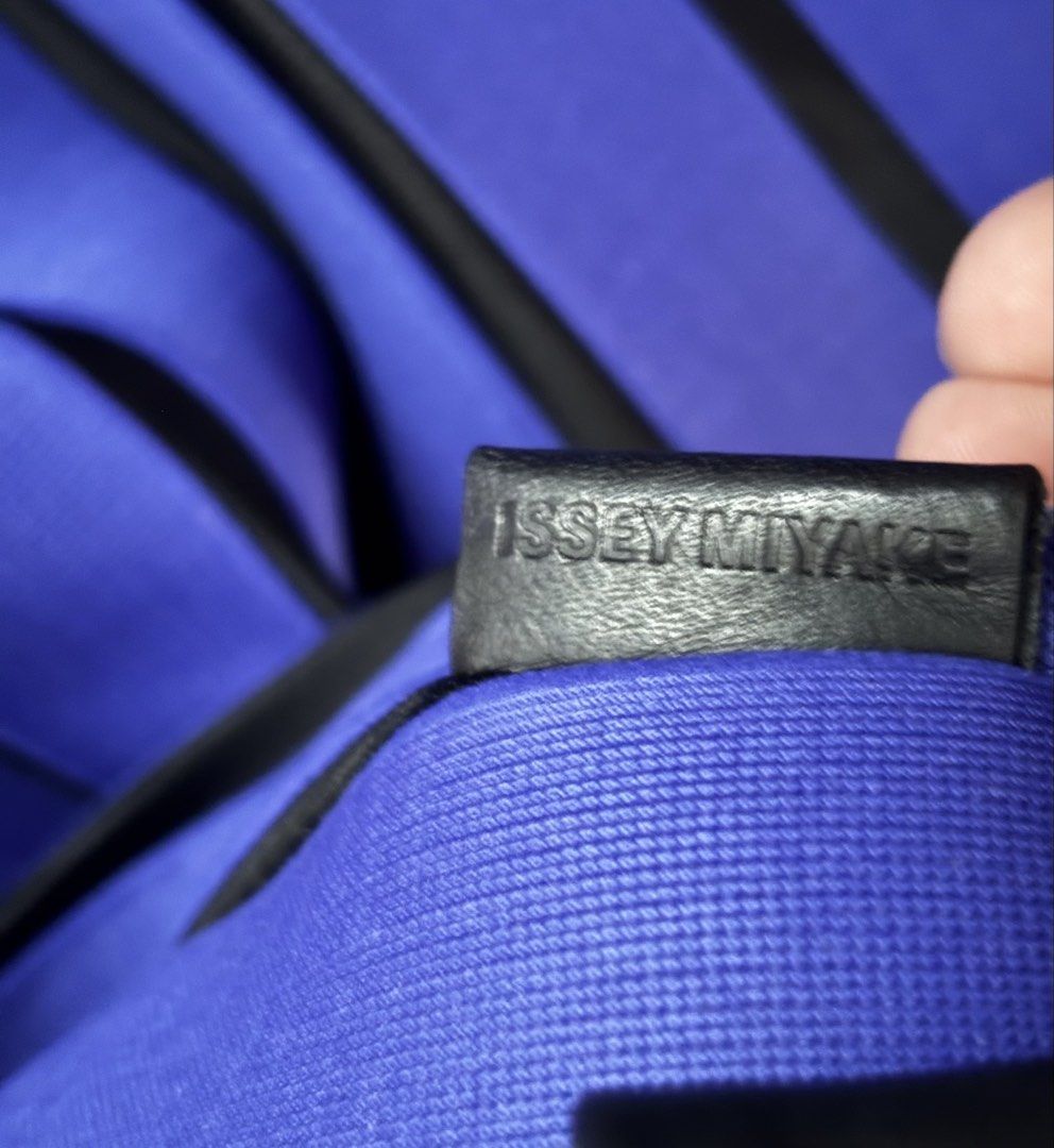 Issey Miyake Pleated Drawstring Bag Purple (Category: Tote Bags) located in Makati City. Submitted by rare_thrift_stuff (Listing ID 1468975125, Image 3). Description: - Brand: Issey Miyake - Style Number: IM72AG550 (Original store tag attached) - Color: Vibrant purple with black contrast piping - Features: Drawstring closure with adjustable leather-like toggles and shoulder straps - Interior: Embossed leather brand tag and 'Made in Japan' label -