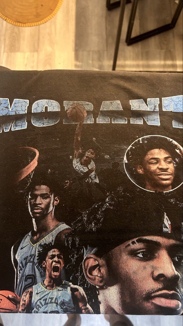 Ja Morant Memphis Grizzlies Graphic Tee (Category: Tshirts & Polo Shirts ) located in Marikina City. Submitted by paolody (Listing ID 1468976692, Image 1). Description: - Color: Black - Material: 100% Cotton - Design: Ja Morant photo collage with distressed text - Fit: Regular fit with short sleeves - Details: Jue Miao tag at the collar - Perfect for: NBA fans and streetwear style.