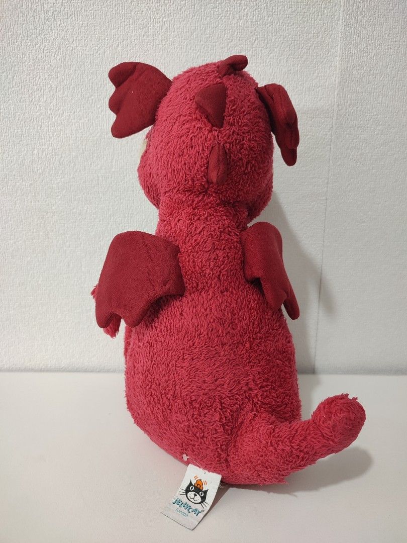 Jellycat Red Dragon Soft Toy (Category: Plushies & Soft Toys) located in Manila. Submitted by epicmountain-f20453 (Listing ID 1469116152, Image 3). Description: - Brand: Jellycat London - Character: Bright red plush dragon - Condition: Brand new with tag attached - Size: Standard medium plush - Features: Textured fur, fabric wings, and a wide smiling face with white teeth - Ideal for: Jellycat collectors, kids, and gifting.